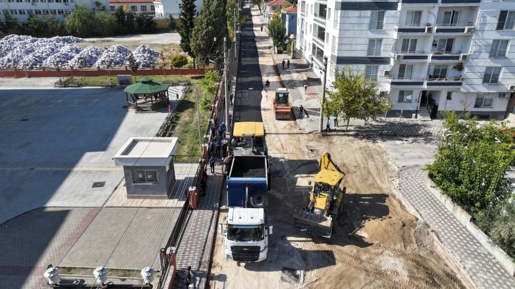Kırkağaç Şair Eşref Mahallesi 79. Sokak'ta asfalt serimi yapan kamyonlar ve iş makineleri